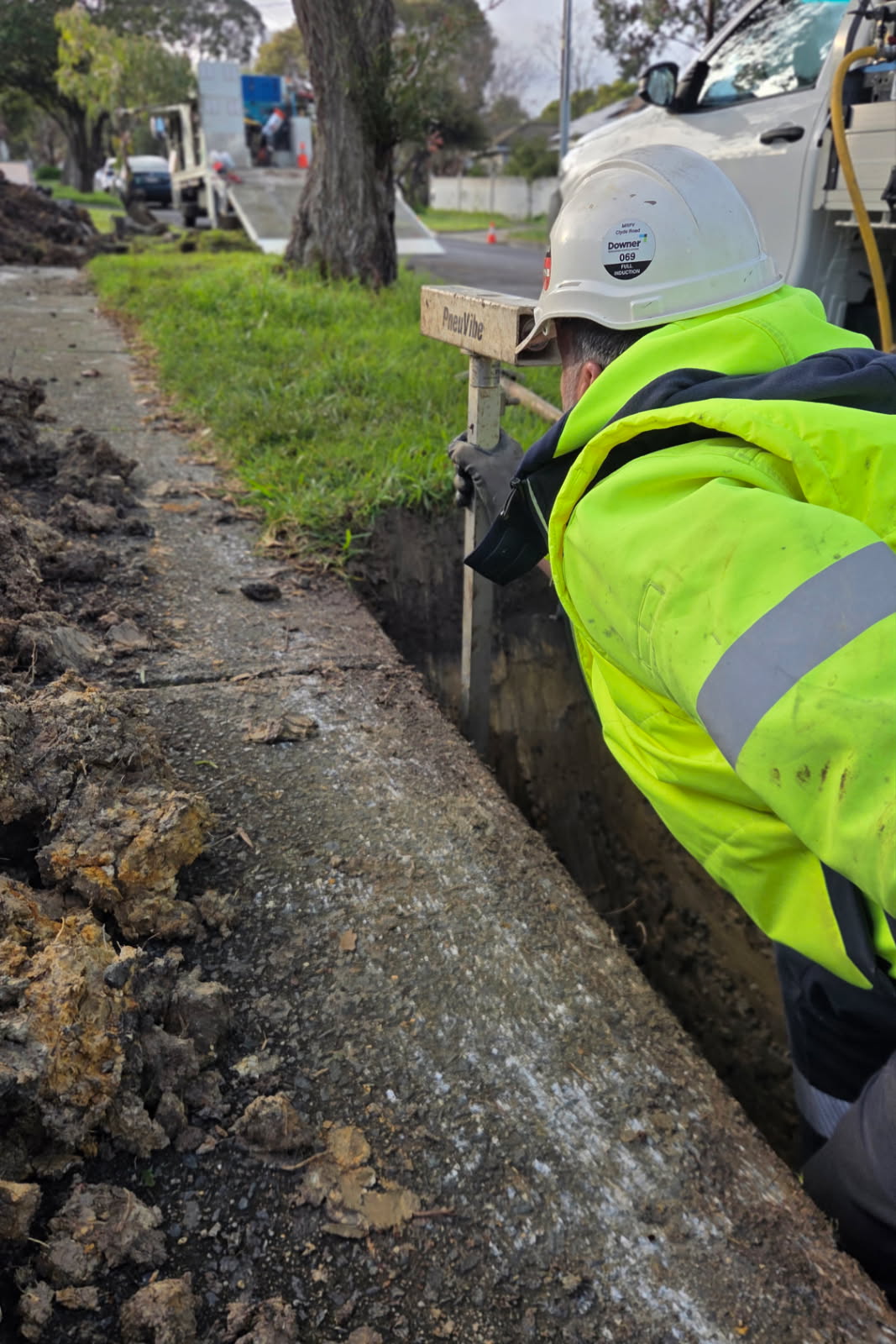 Electra Civil crew member inspecting an open street trench
